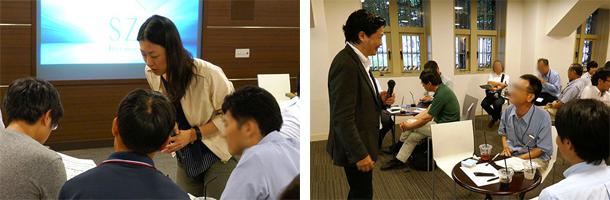 写真6 ディスカッション中に各テーブルを回る原さん(左)と青野さん(右)